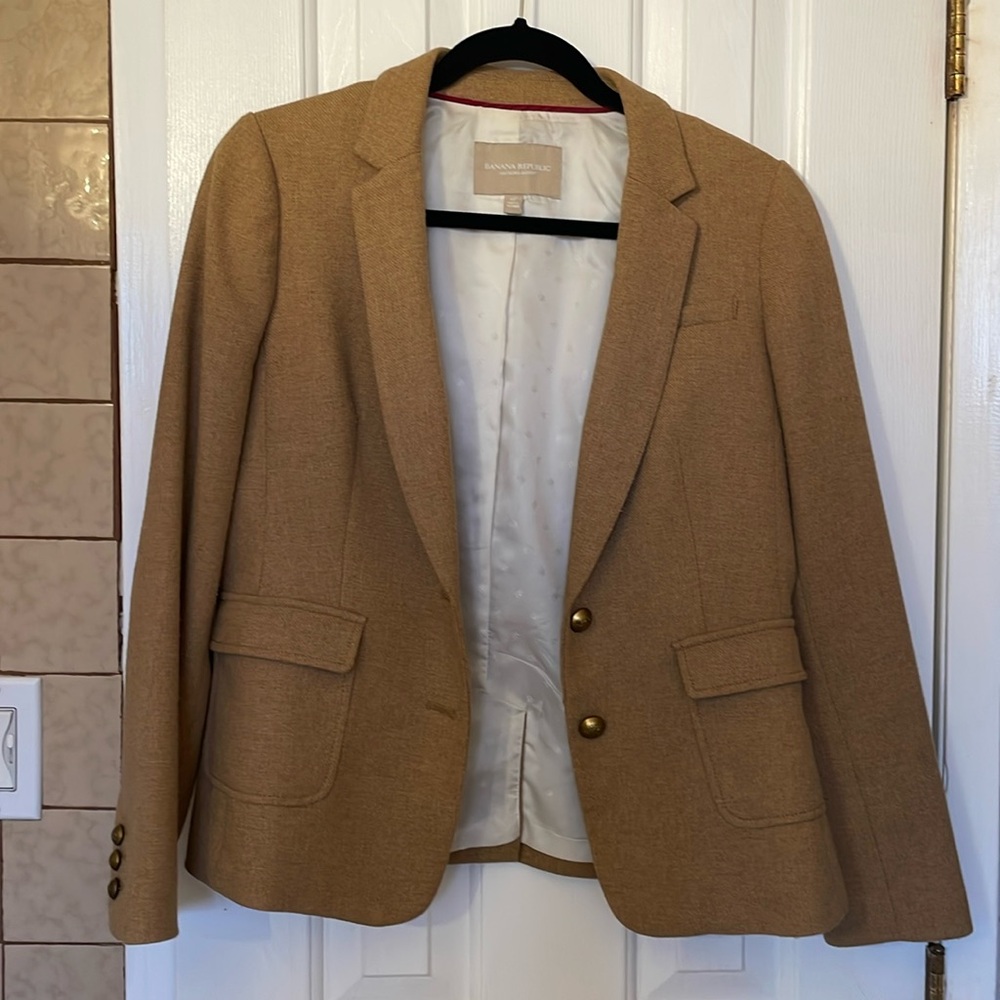 Beautiful camel color jacket with elbow patches and working pockets. Lovely